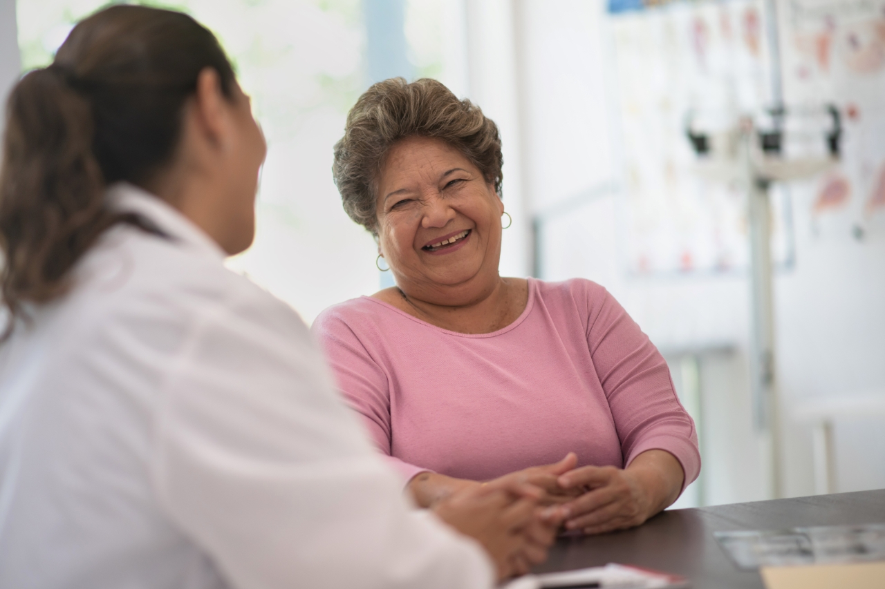 Older woman speaking and consulting with the doctor about her concerns